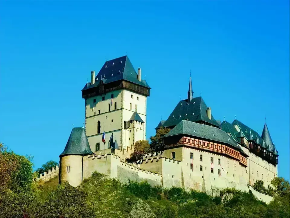 The majestic Karlštejn Castle viewed from a distance with the village below.